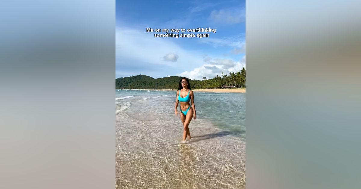 Image of Nicole Scherzinger sunbathed on the sand.