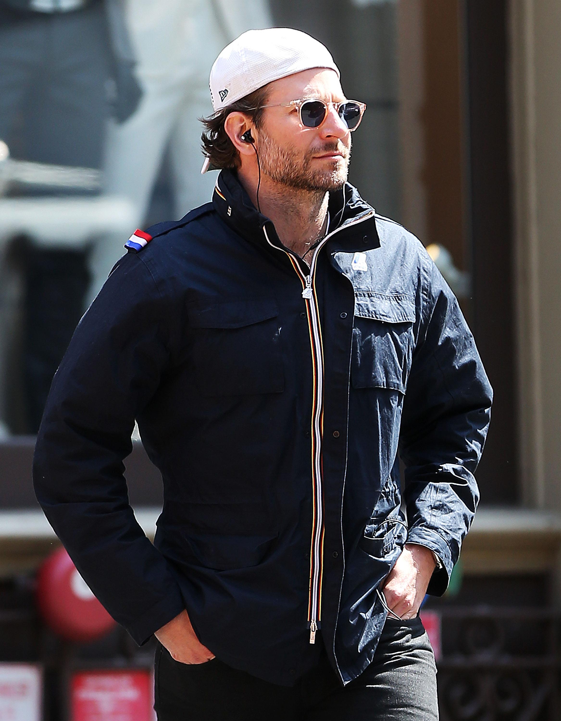 Bradley Cooper checks his phone as he walks in SoHo, NYC