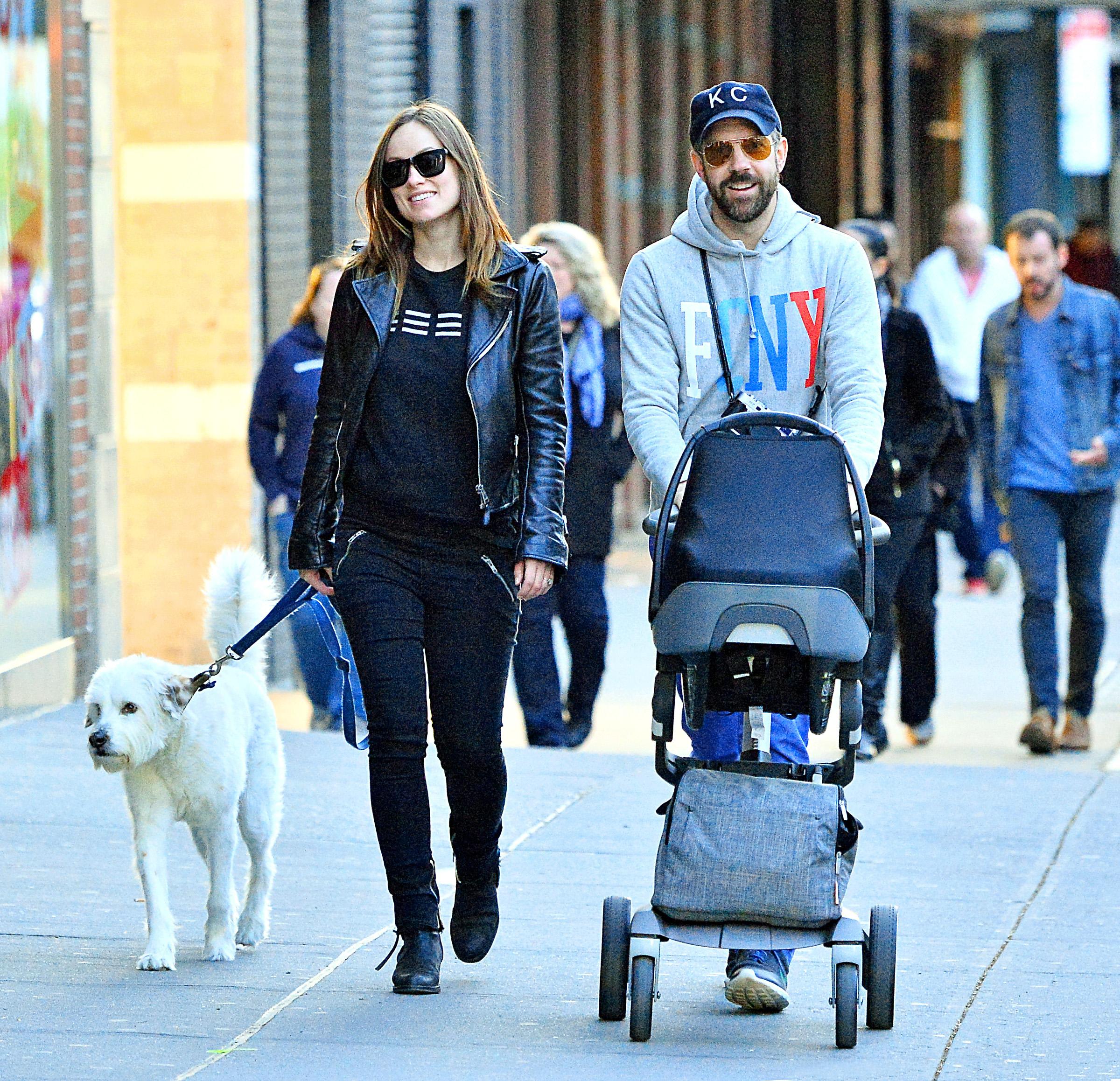 Olivia Wilde and Jason Sudeikis are all smiles as they take a stroll with their son Otis and dog Paco in NYC