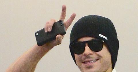 Zac Efron and Seth Rogen take selfies with fans before boarding a flight at JFK Airport