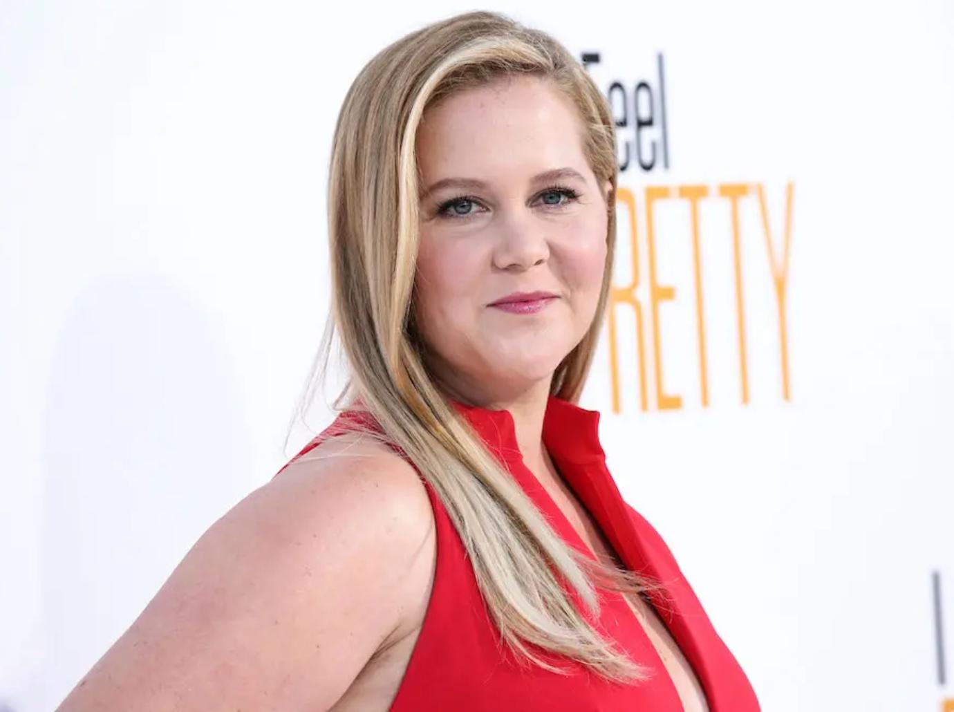 amy schumer poses lying down gynecologist stirrups photo