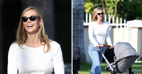 model karlie kloss smiles as she takes a walk with her baby and a friend