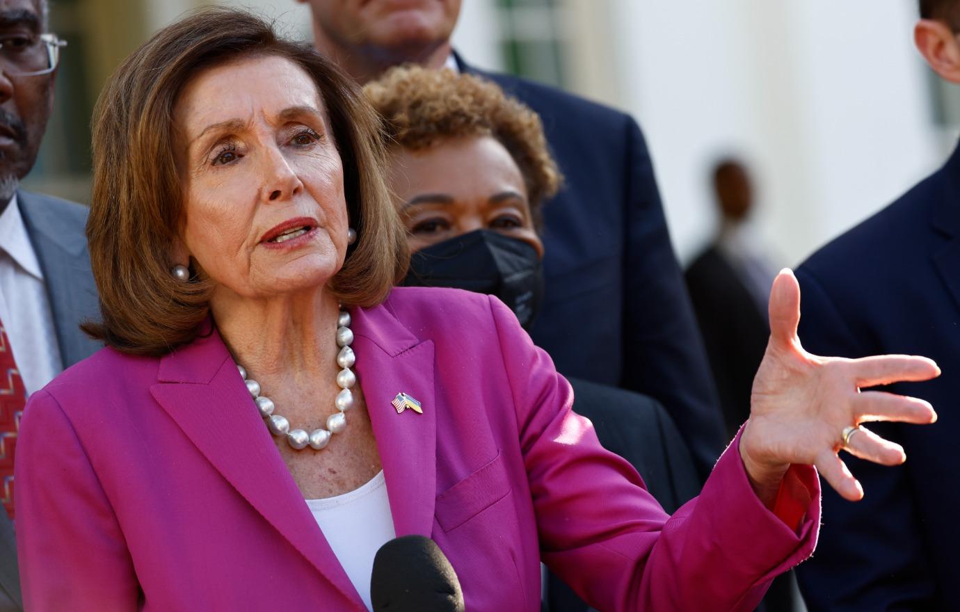 Photo of Nancy Pelosi in a pink pantsuit.