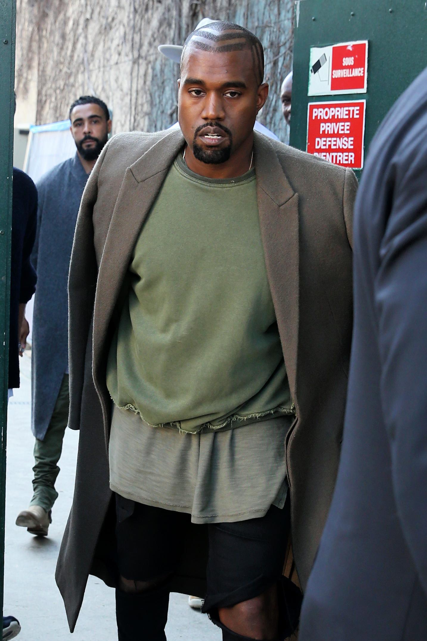 Rapper Kanye West arrives in his matted black Porsche at Celine Womenswear SS 2015 at Tennis Club de Paris on September 28, 2014 in Paris, France