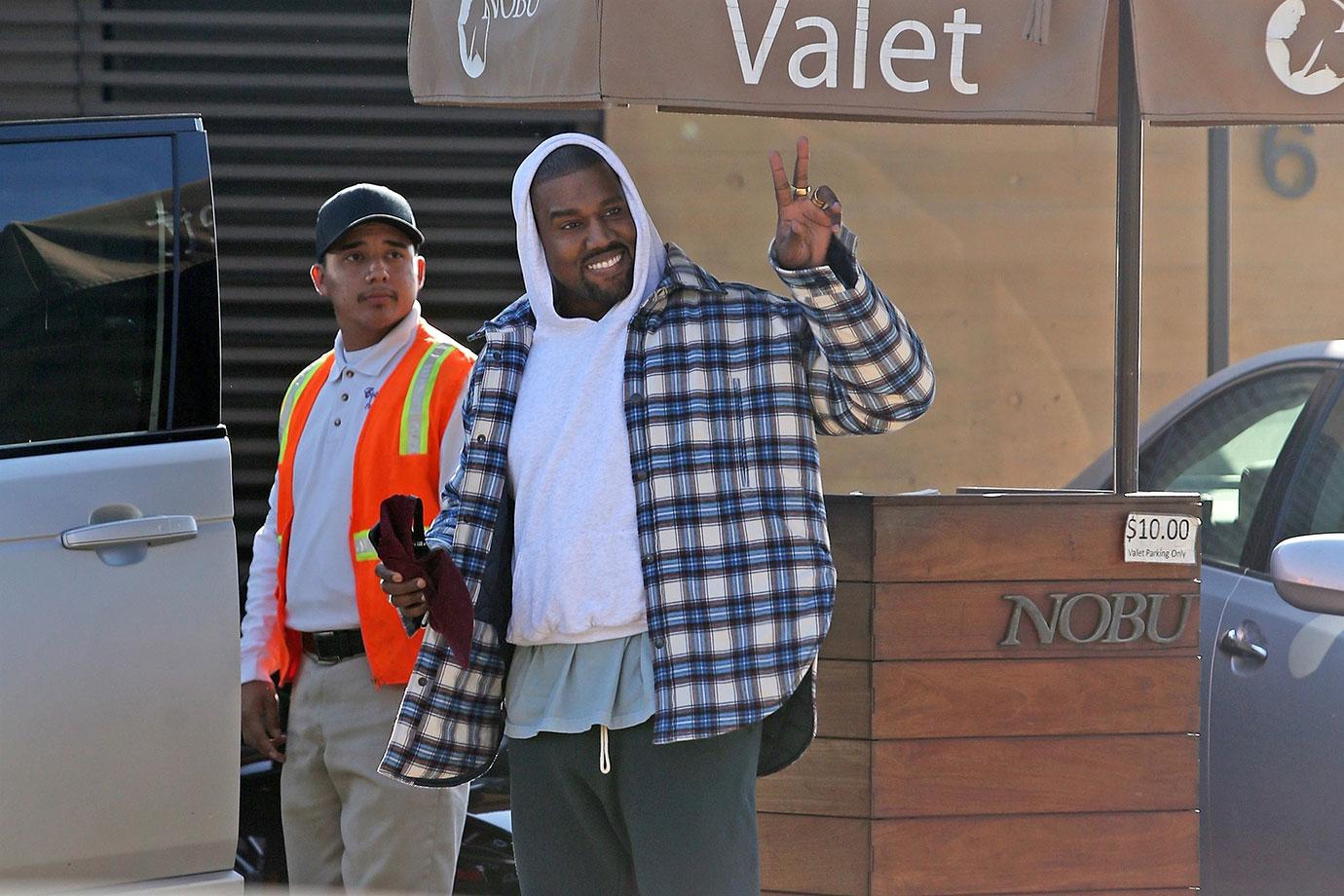 Kanye West is in good spirits as he leaves Nobu with a friend