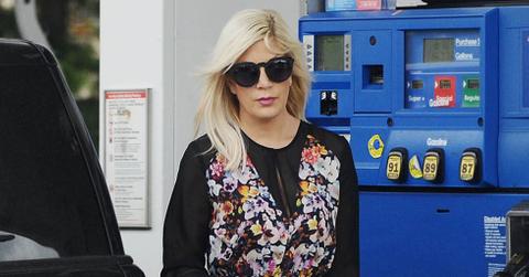 EXCLUSIVE: Tori Spelling pumps gas while stepping out in a floral print dress