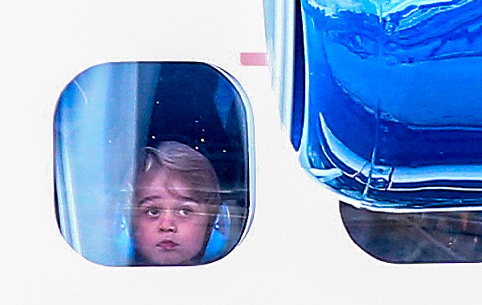 Adorable Prince George looks out of the plane window as he say goodbye to Canada