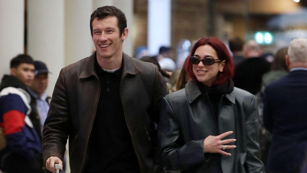 Image of Callum Turner leaned in to kiss Dua Lipa while the newlyweds posed together on the red carpet at the film premiere.
