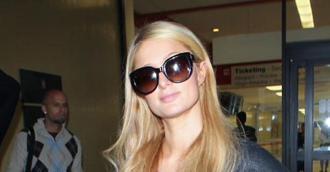 INF – Paris Hilton wears a black skull sweater as she returns from Mexico