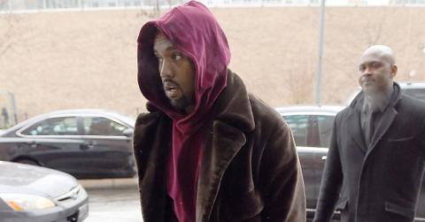 Kanye West seen wearing a purple hoodie and brown fur coat in New York City