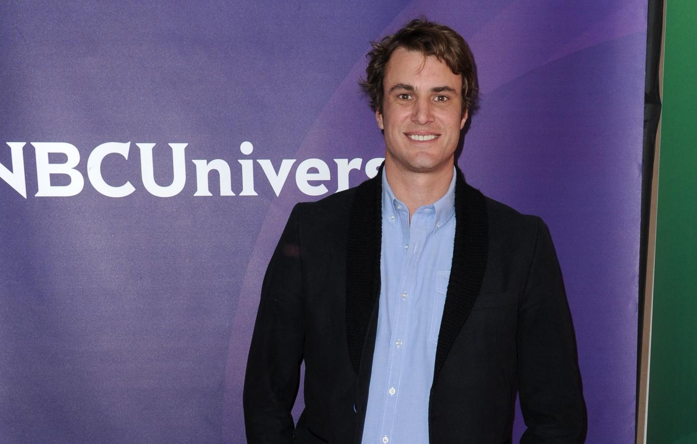 Southern Charm star Shep Rose poses in a black blazer in blue dress shirt