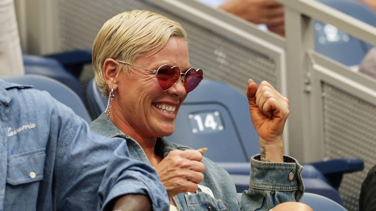 Image of Pink appeared to be having a blast at the U.S. Open while sporting heart-shaped sunglasses and a denim jacket.