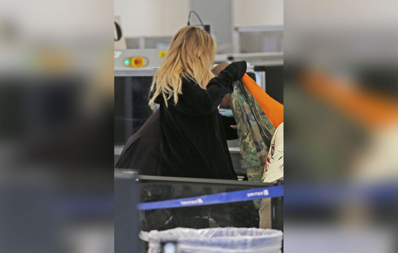 Pregnant Khloe Kardashian Covers Up in Camo at LAX Airport: Photo