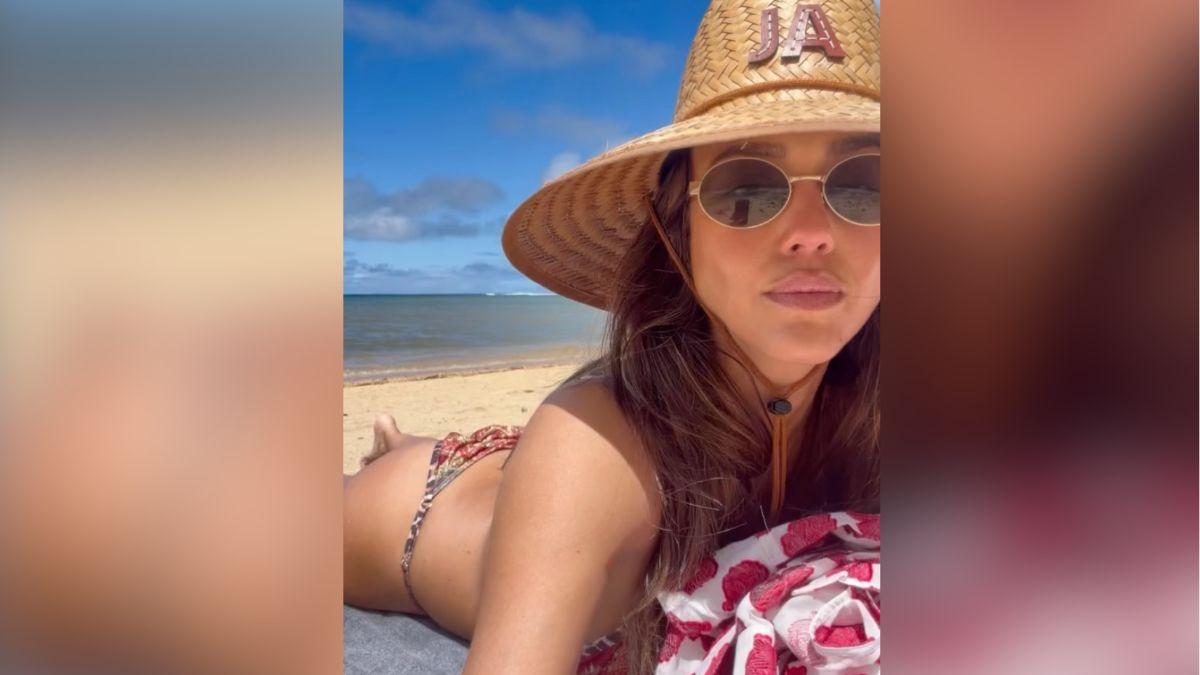 image of Jessica Alba wore a straw hat with he initials on it.