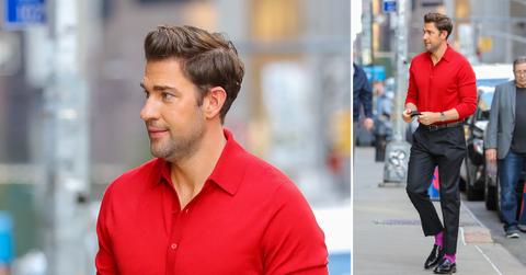 john krasinski seen wearing a red shirt and a purple socks while arrives at the late show with stephen colbert ok