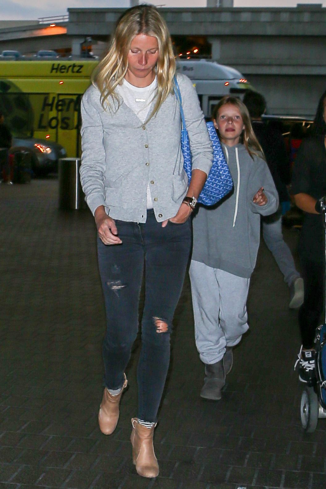 A shy Gwyneth Paltrow heads through LAX with Moses and Apple **USA ONLY**