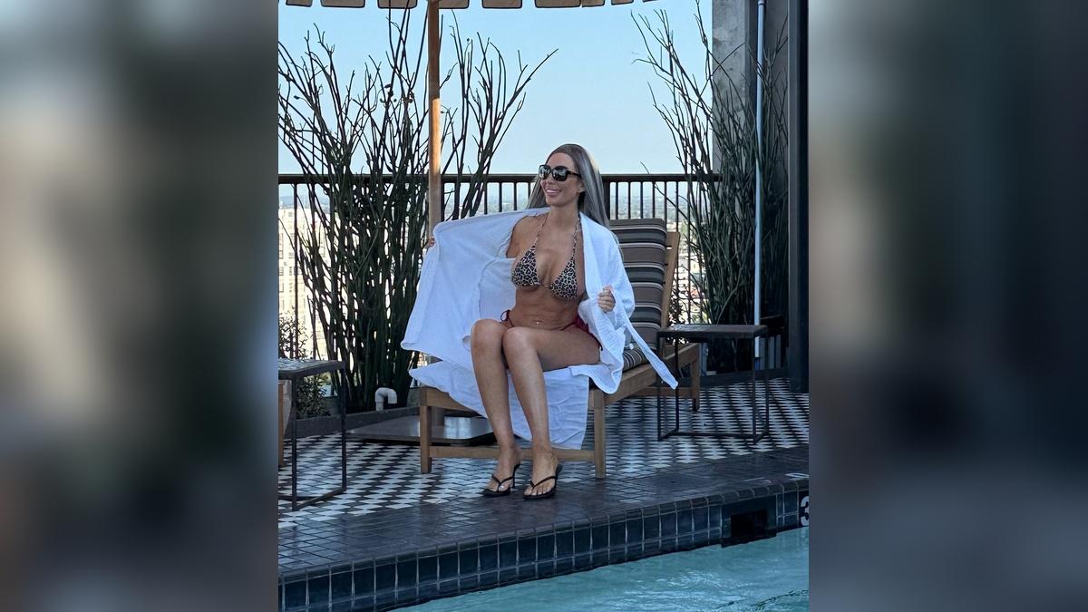 image of The former 'Teen Mom' star paired the tiny swimsuit with an oversized white cover-up and black sandals.
