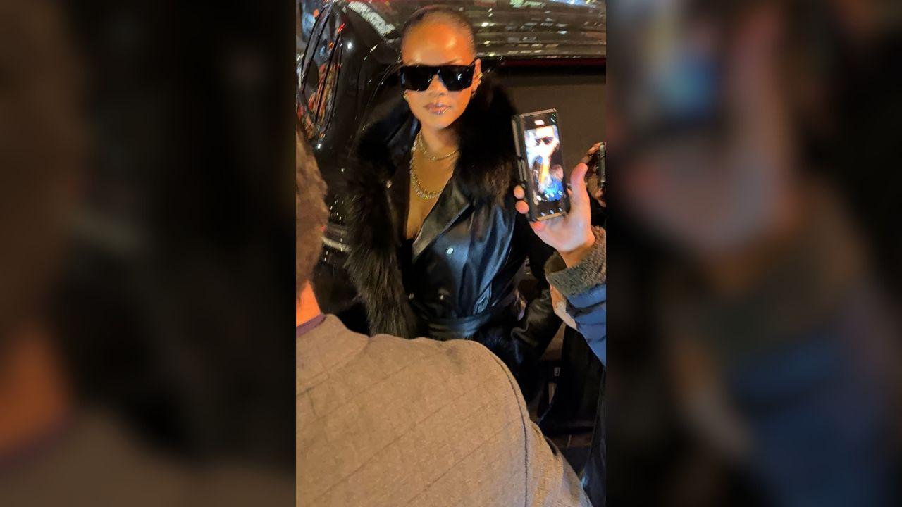 Image of Rihanna dazzled in a sleek black dress and matching jacket.