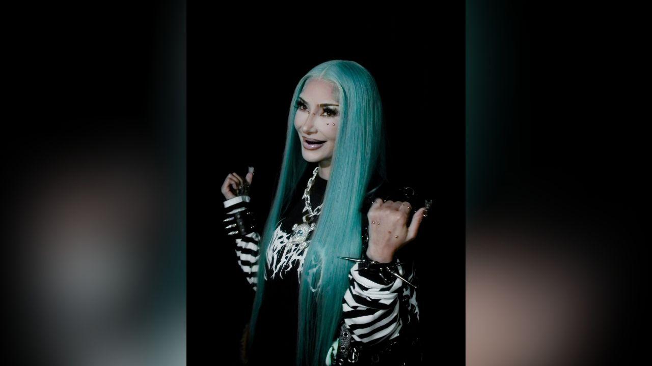 Image of Kim Kardashian showed off decorative facial and hand piercings.