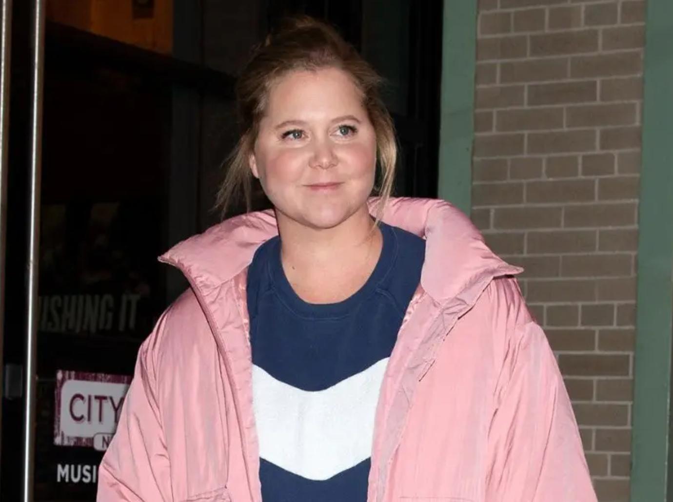 amy schumer poses lying down gynecologist stirrups photo