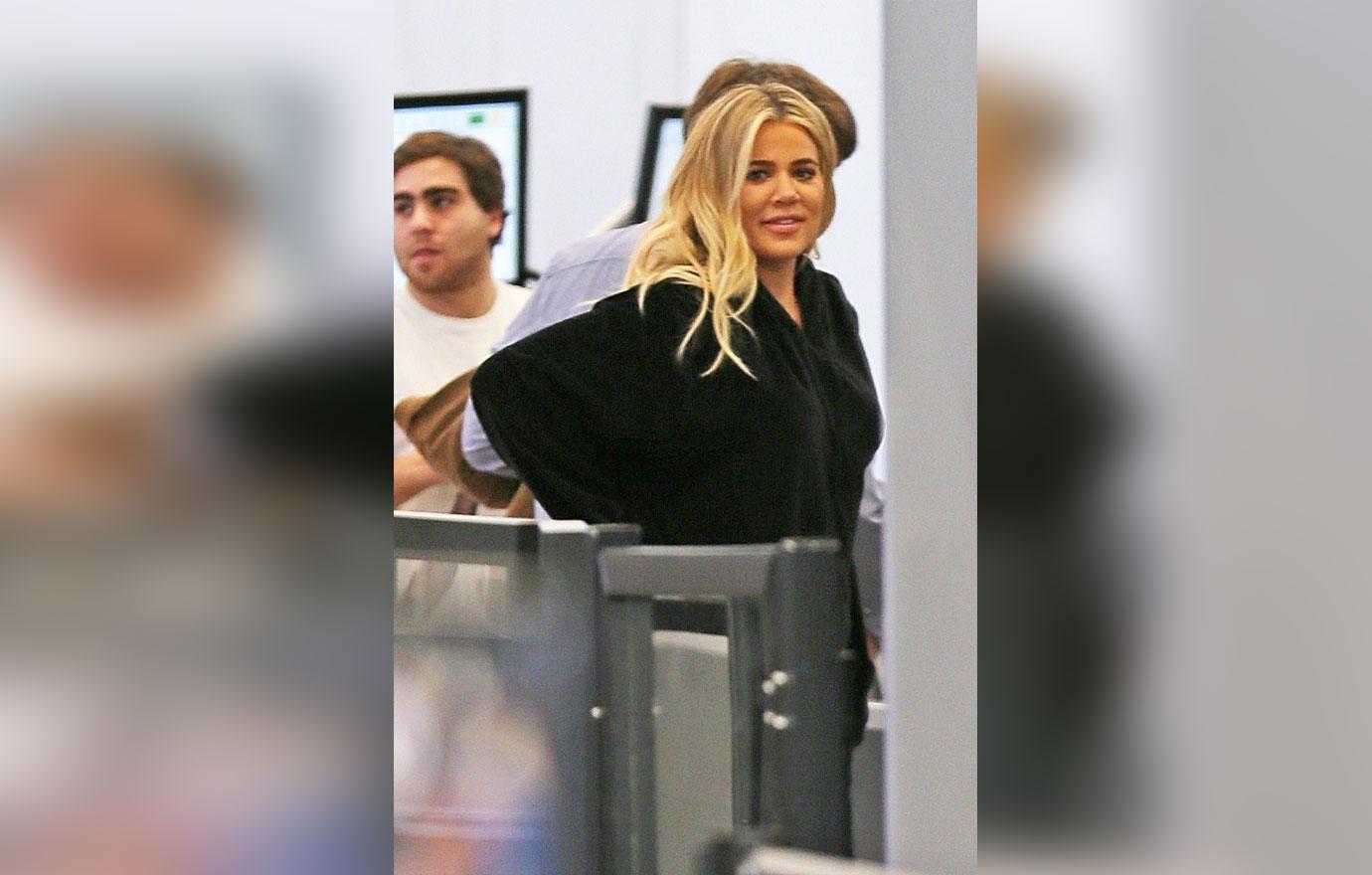 Khloe Kardashian hides her baby bump as she departs LAX