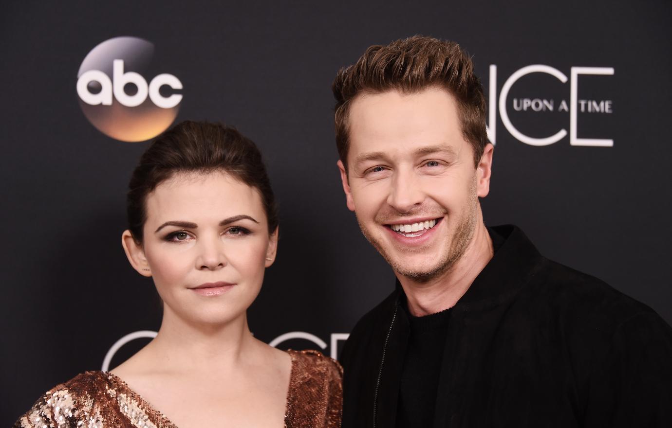 Ginnifer Goodwin and Josh Dallas smile in front of an ABC press backdrop