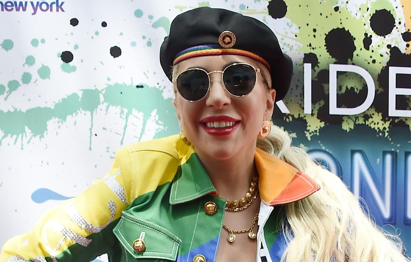 Lady Gaga looked every bit the pride symbol in jean shorts and thigh-high rainbow sparkled boots with a black beret on her head, while a rainbow jean jacket covered a black tube top.