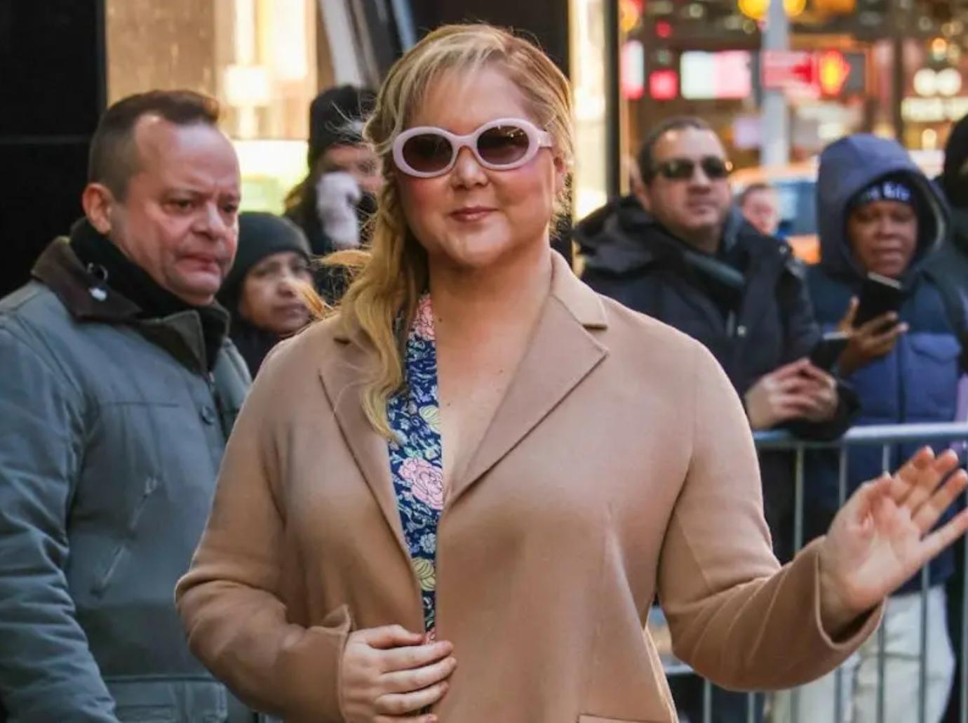 amy schumer poses lying down gynecologist stirrups photo