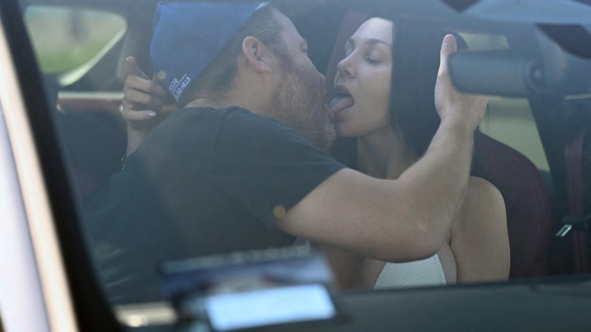 image of The two had an intimate moment inside a car.