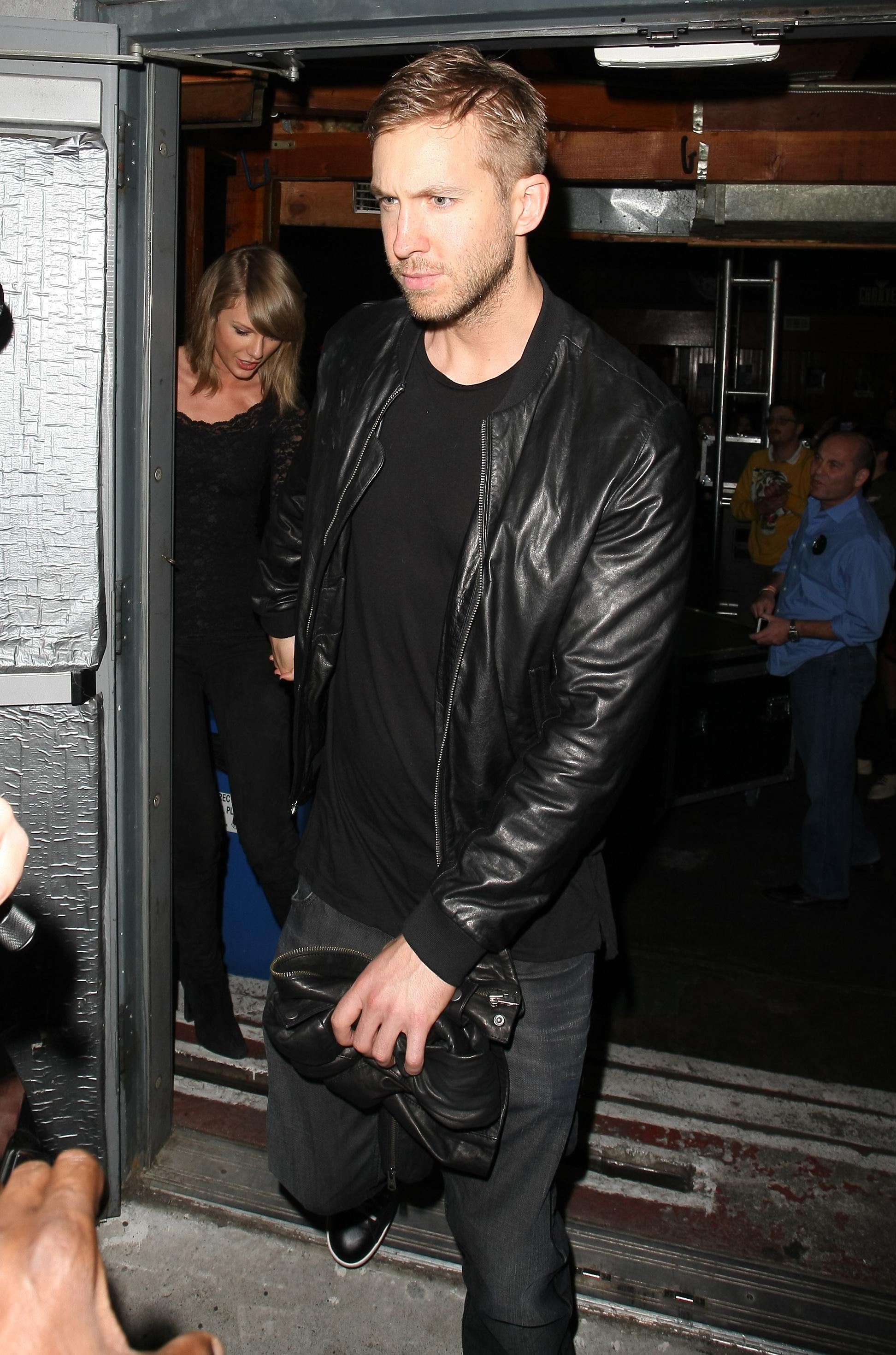 Mobbed by photographers and fans singer Taylor Swift and her rumored boyfriend Calvin Harris leaving Troubadour club holding hands, in West Hollywood,CA