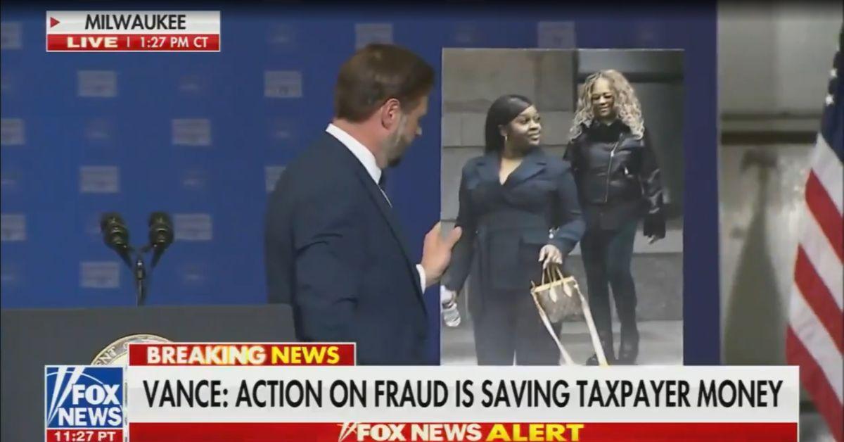image of J.D. Vance used a large placard during a speech in Milwaukee to discuss a federal healthcare fraud case involving Markita Barnes.
