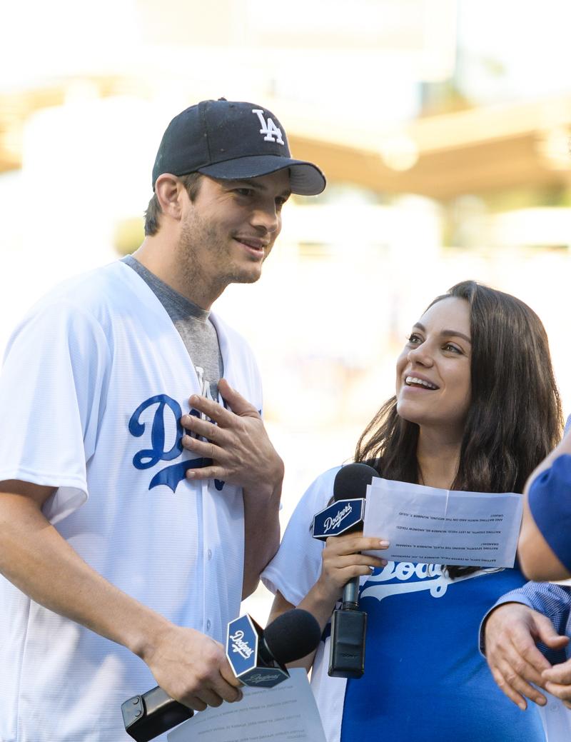 Pregnant Mila Kunis and hubby Ashton Kutcher put on PDA in matching outfits  at LA Dodgers crucial playoff game