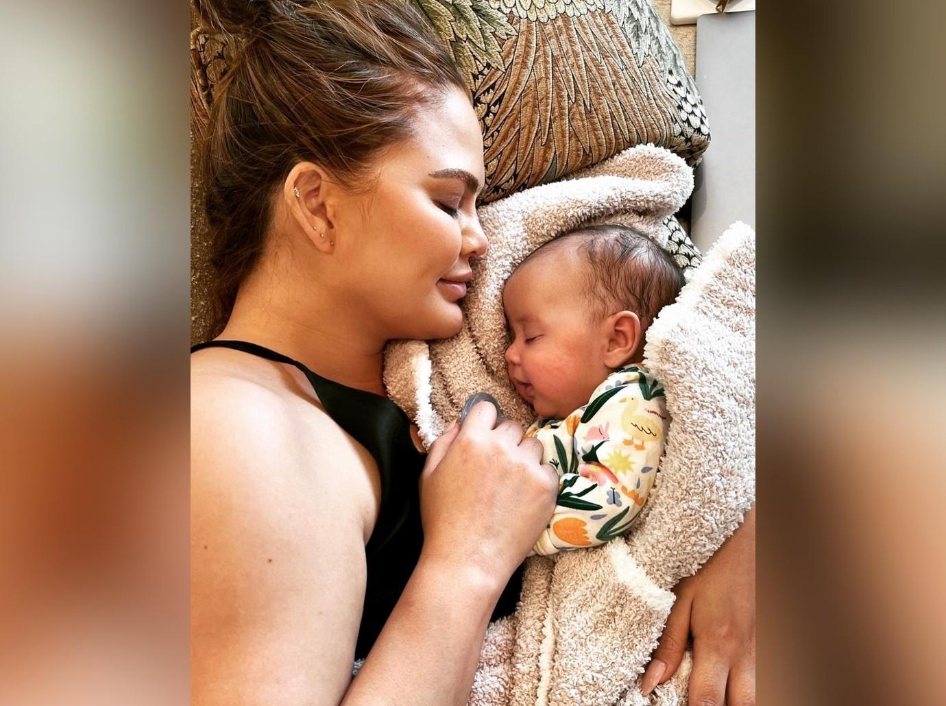 chrissy teigen cuddles daughter esti photos