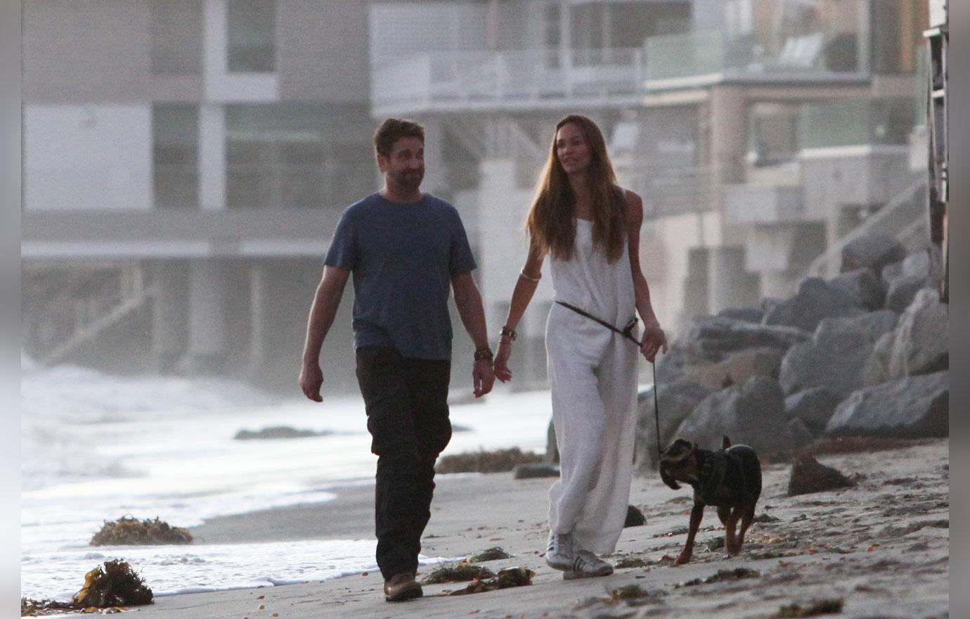 EXCLUSIVE: Gerard Butler and girlfriend Morgan Brown take a romantic stroll on the beach in Malibu, CA