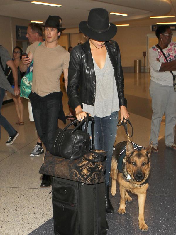 Nikki Reed and Ian Somerhalder wear matching hats as they arrive in Los Angeles with Reed&#039;s Service Dog