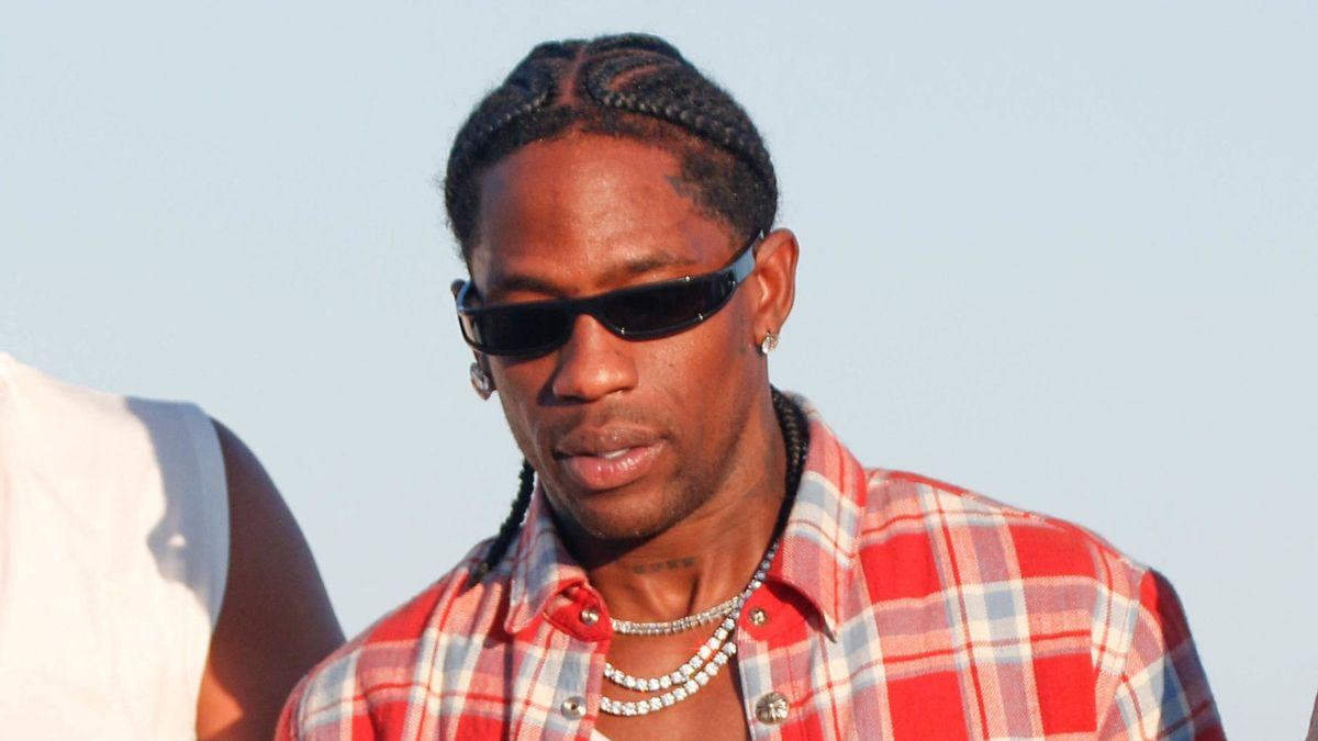 Image of Travis Scott's team reportedly began throwing bottles after the rapper thought someone was recording him.