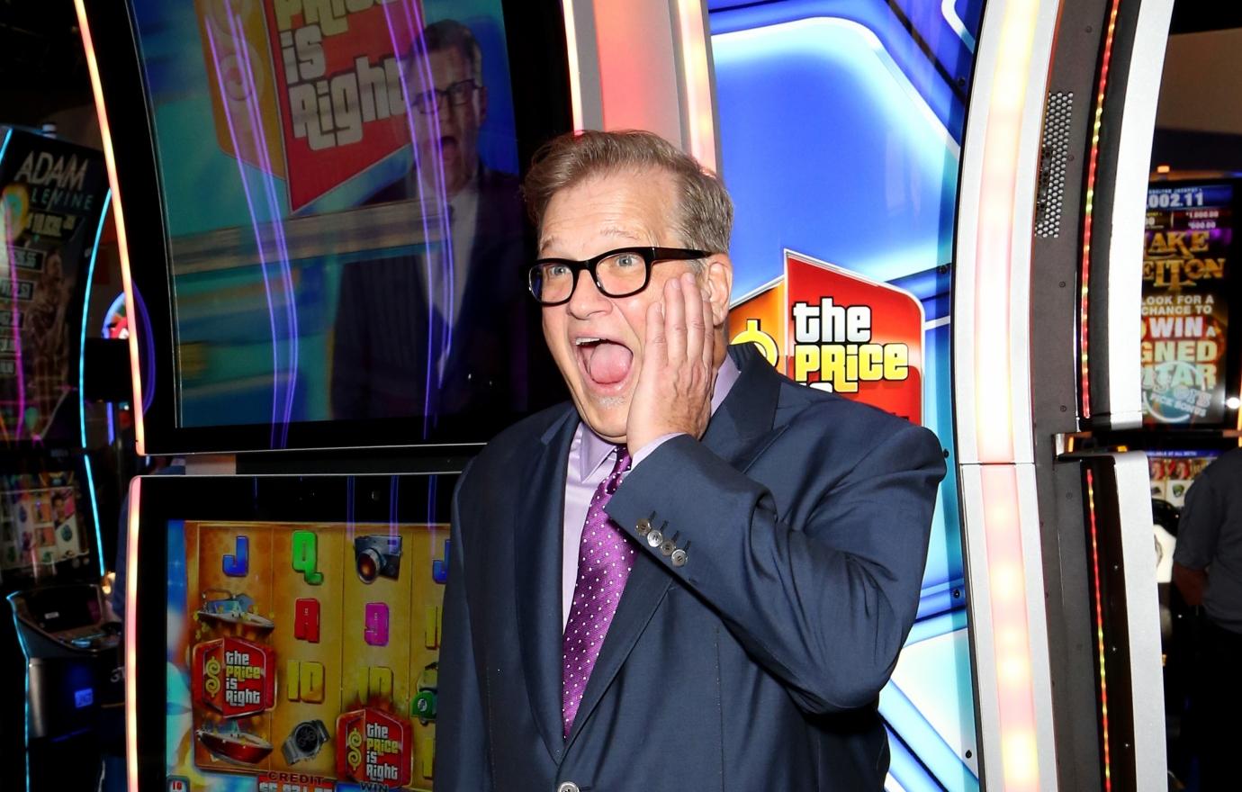 Drew Carey in front of the Price Is Right big wheel at a convention in 2018