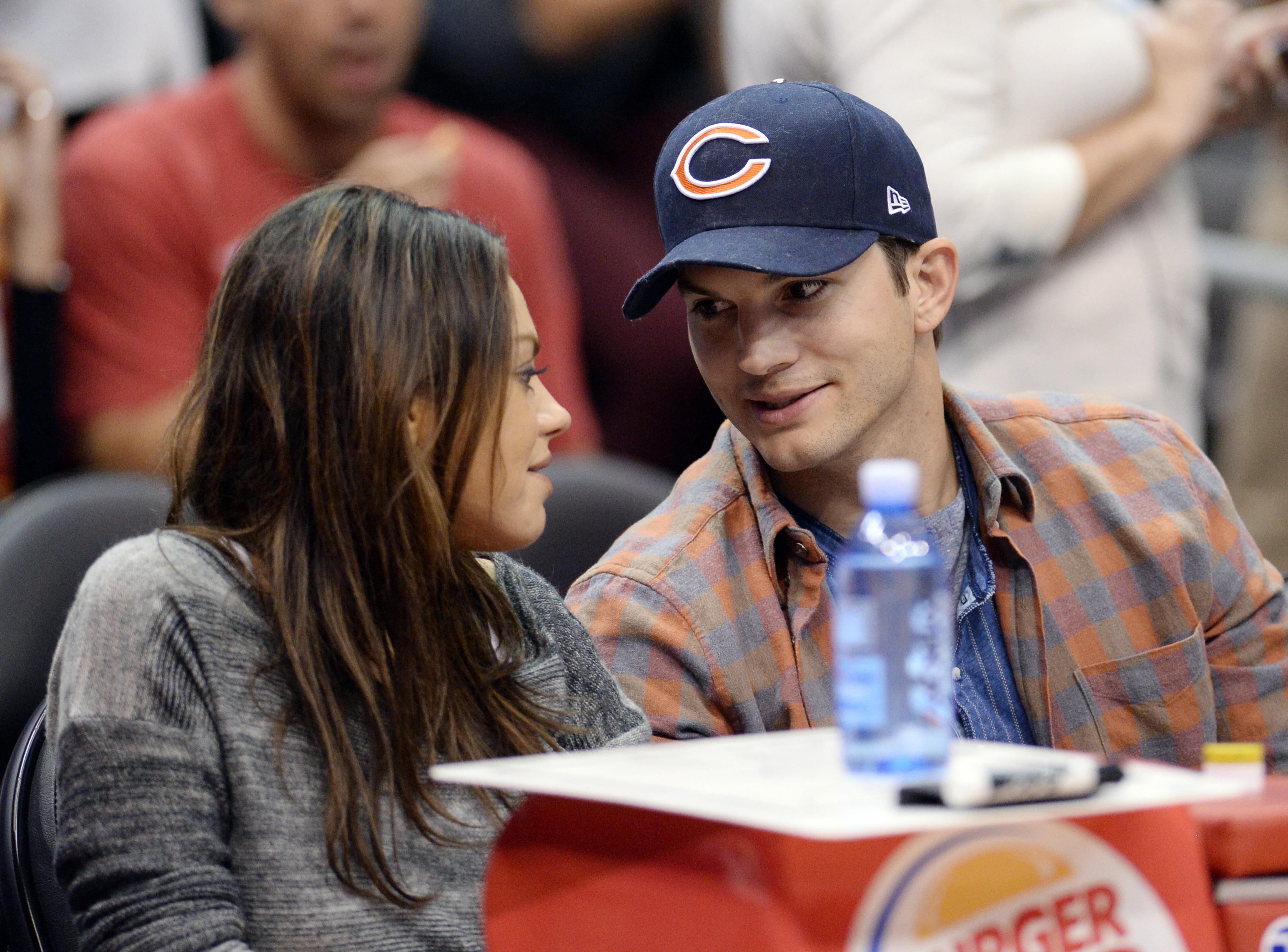 Mila Kunis and Ashton Kutcher at the Clippers v Pistons, game at the Staples Center in Los Angeles, CA