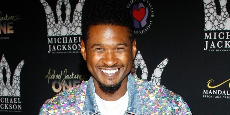 Usher Smiling At An Event