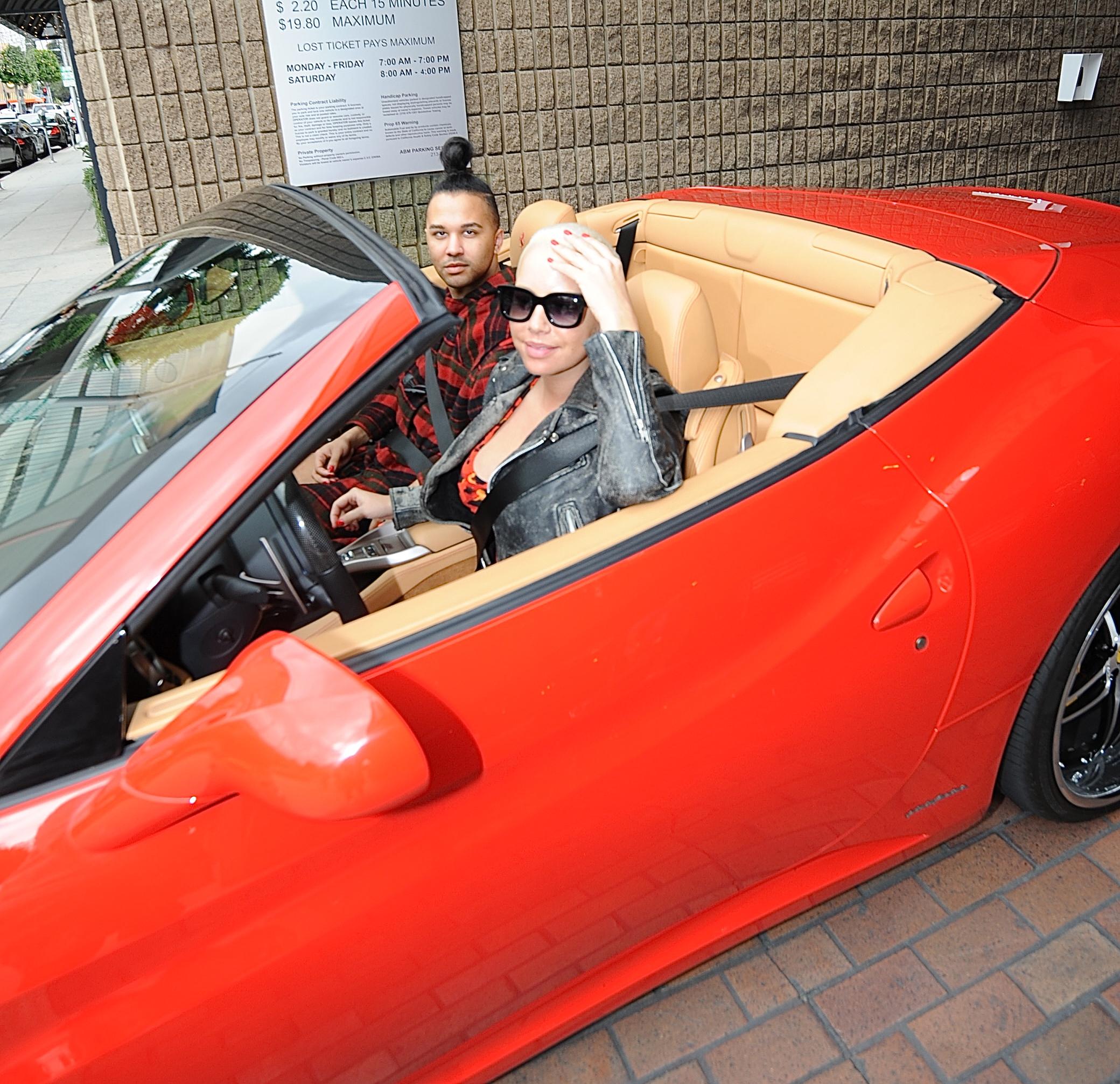 Amber Rose gets a flat tire in her new cherry red Ferrari