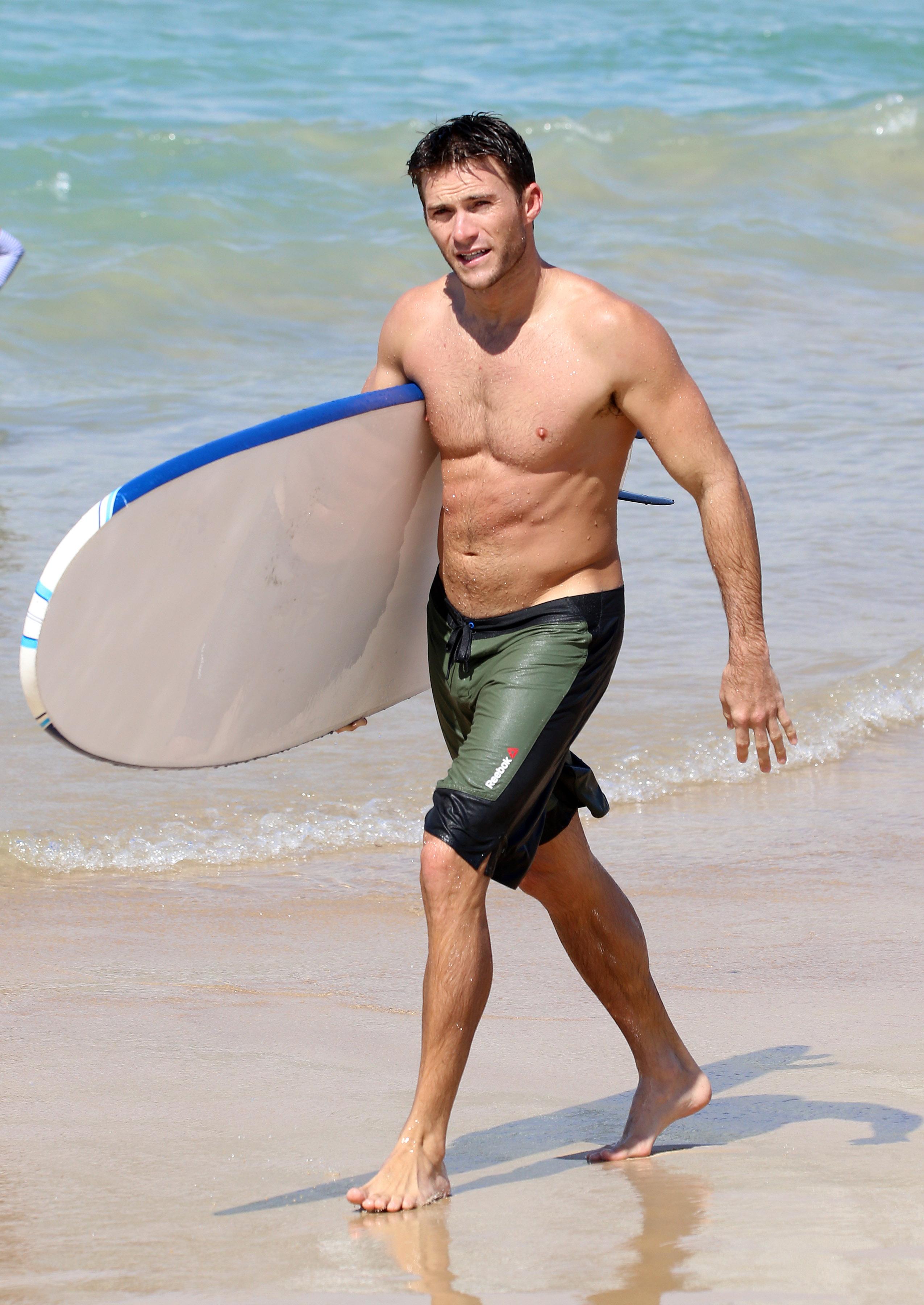 EXCLUSIVE: Scott Eastwood shows off his muscles while surfing at Bondi Beach.