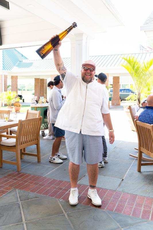 fashion designer and saint james iced tea co founder jon buscemi celebrates a victory with tequila don julio  at the first annual saint james open on june