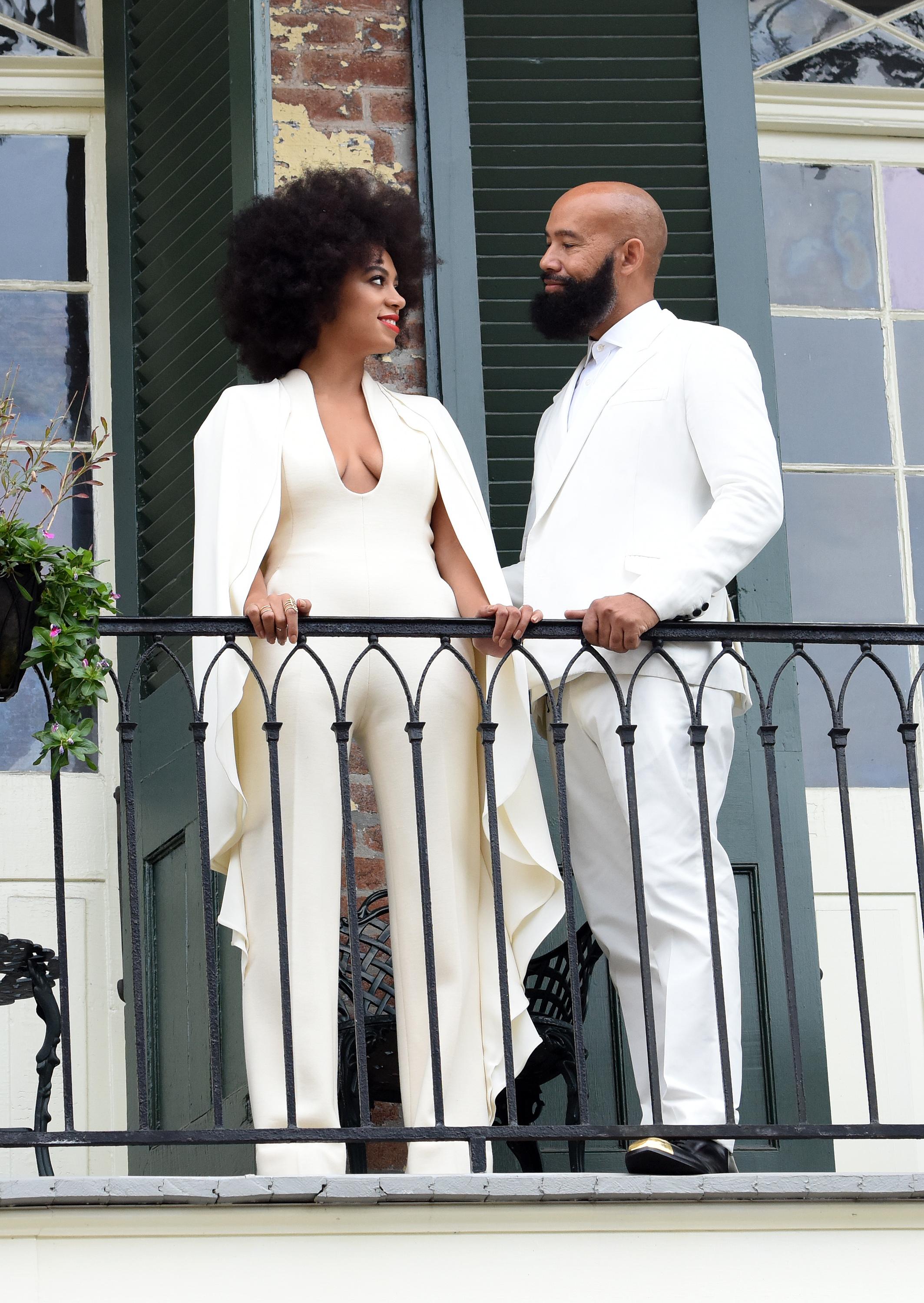 Solange Knowles wears a white pantsuit on her Wedding day while posing with Fiance Alan Ferguson on a balcony just before the Wedding