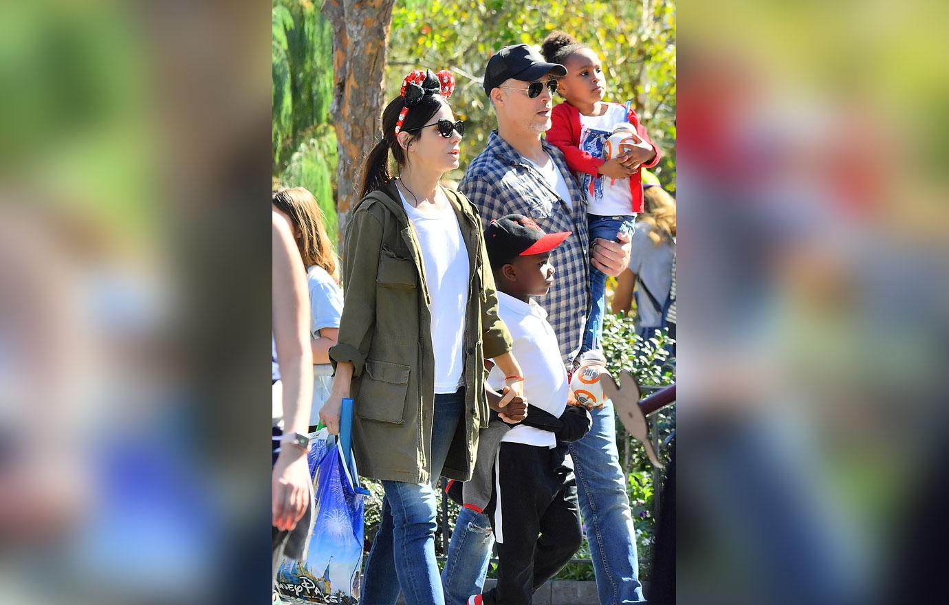 EXCLUSIVE: Sandra Bullock and her boyfriend Bryan Randall are joined by Jason Bateman and his family while spending the day at Disneyland