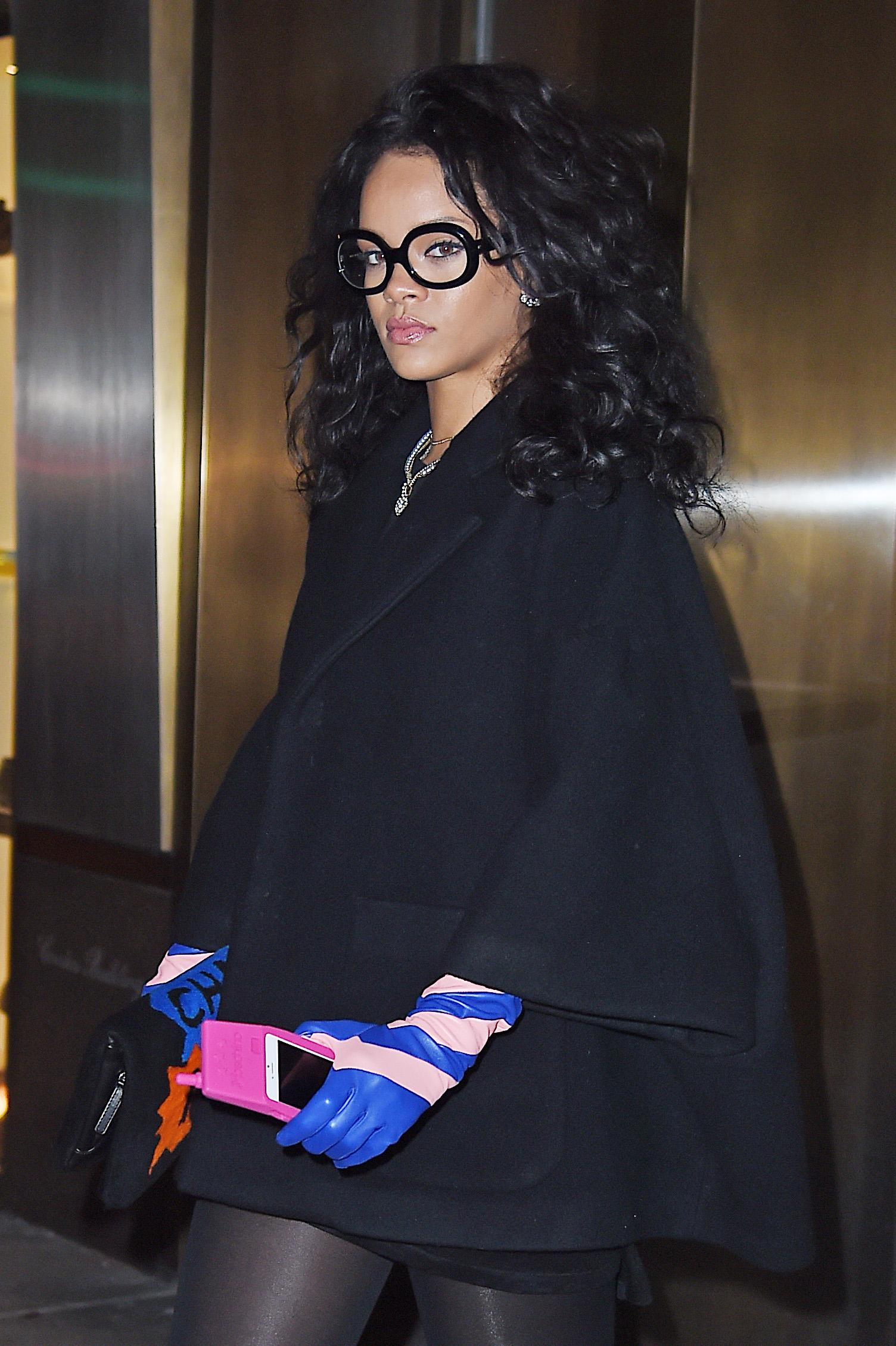 Rihanna steps out with a super cool iPhone case as she leaves an office building in Midtown, NYC