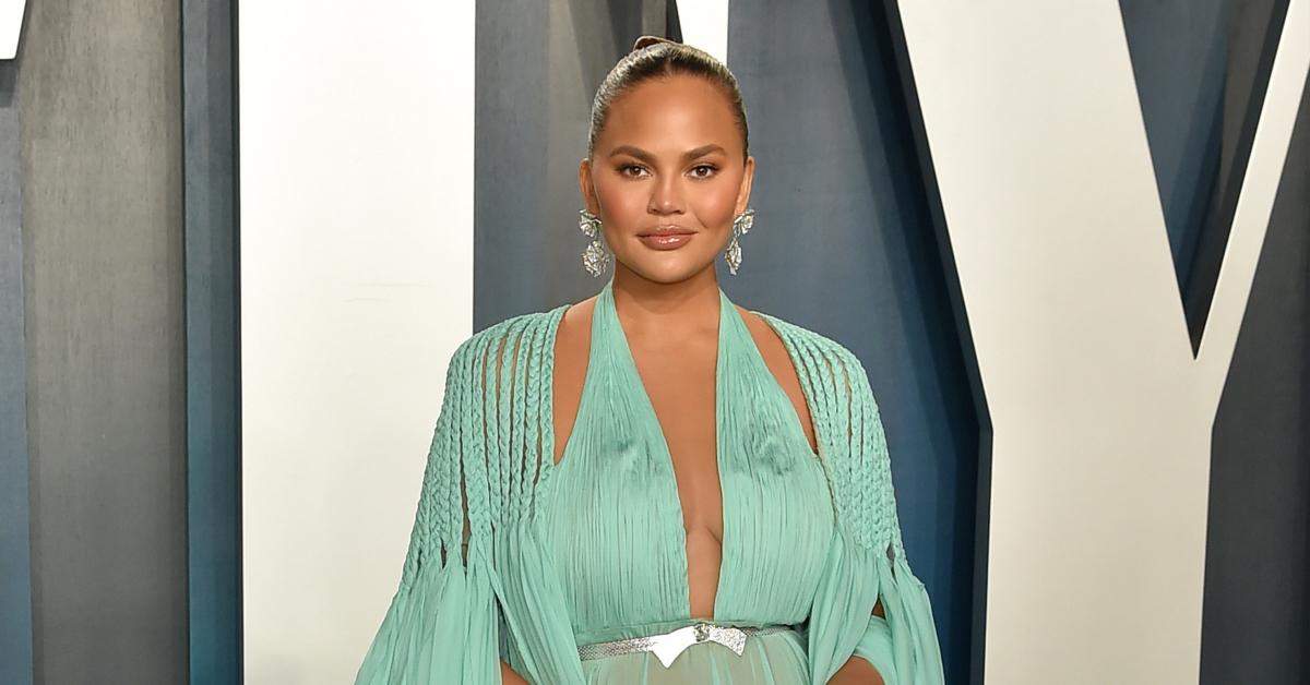 Chrissy Teigen's boobs pop out of her incredibly revealing