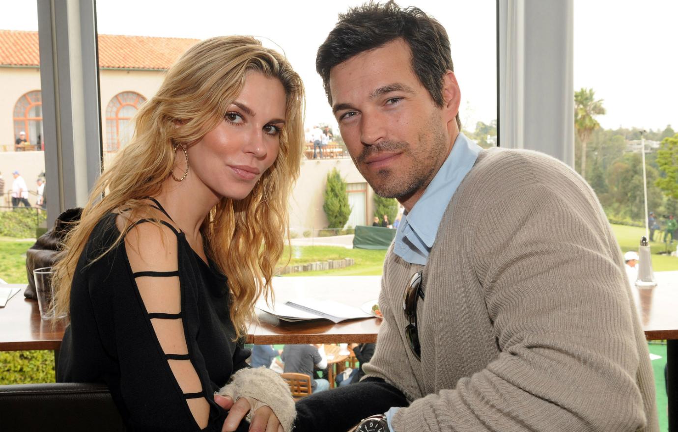 Brandi Glanville wears a black shirt with cutout sleeves, with Eddie Cibrian wearing a tan sweater over a blue shirt in this 2009 photo.