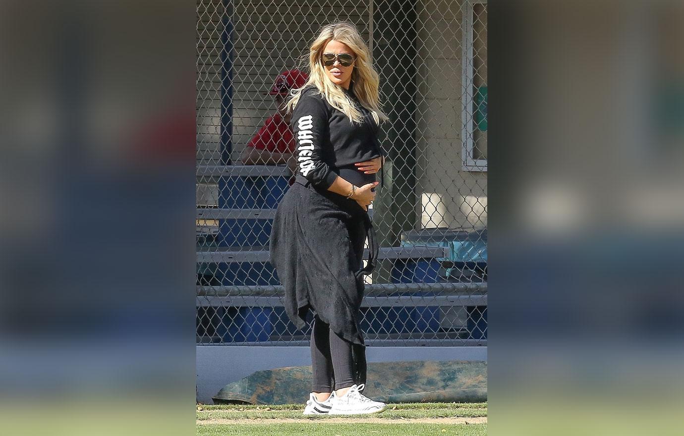 *EXCLUSIVE* Khloe Kardashian caresses her baby bump on the Baseball Diamond