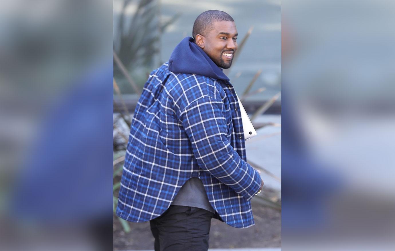 Kanye West arrives at his office in a happy mood