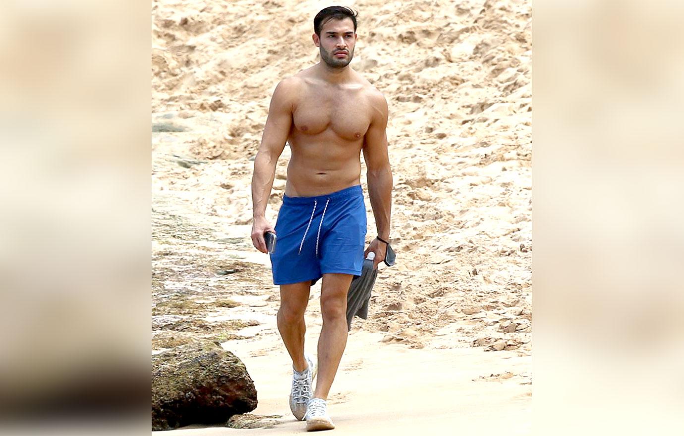 britney spears boyfriend sam asghari takes a solo stroll on the beach while on vacation in maui ok